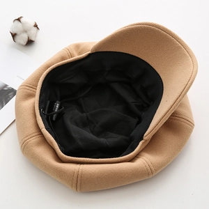 Detail view of newsboy cap lining with 30% wool blend label and adjustable string