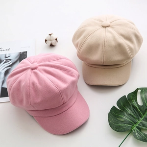 Detailed top view of pink and beige wool newsboy caps with soft wool texture for winter