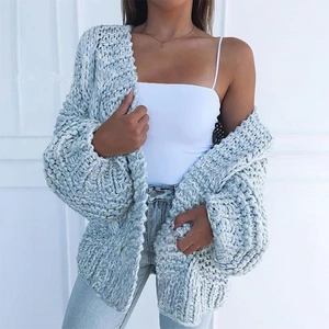 Close-up of thick chunky knit texture on a light blue mohair cardigan sweater
