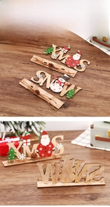 Close-up of XMAS wooden letters featuring Santa patterns and natural pine cones