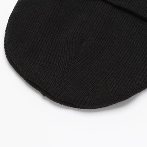 Close-up of black ribbed knit beanie showing high-quality stitching on the top
