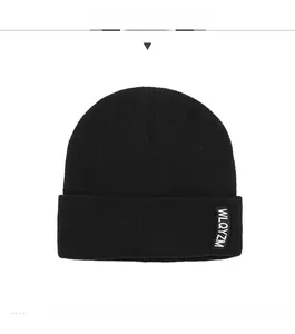 Detailed knit texture and WLQYZM label on a black winter beanie with folded cuff