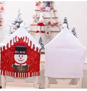 Detail view of front and back snowman chair covers with Warm Wishes sign and festive decor