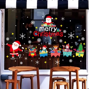 Christmas window stickers featuring Santa Claus and a gift train on a glass storefront