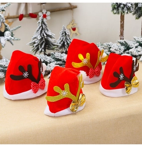 Close-up of red velvet Christmas hats with sequined antlers for pets or bottles