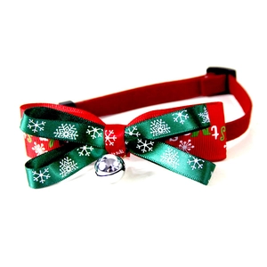 Christmas pet collar with red and green snowflake bowknot and silver bell on white background