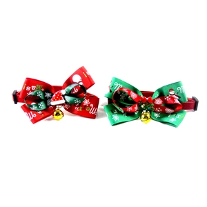 Detail of red and green Christmas pet collars with bowknot ribbons and festive bells