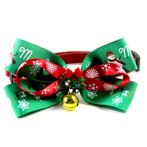 Christmas pet collar with bow, golden bell, and tree charm in festive red and green