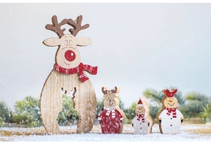 Detailed view of wooden Christmas reindeer and snowman desktop ornaments with falling snow