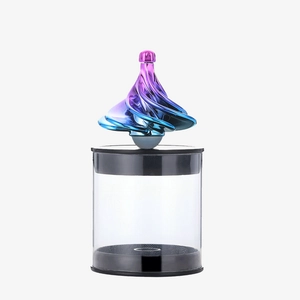 Macro detail of wind-driven colorful gradient spiral top with transparent base stand