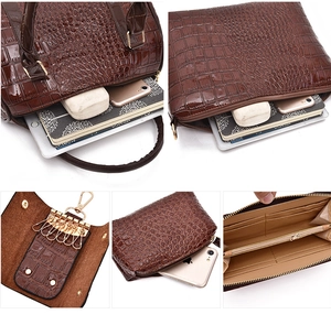 Deep brown crocodile embossed handbag set with gold hardware and interior organizer detail