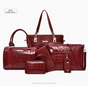 Detail shot of 6-piece red crocodile pattern handbag set with glossy finish and gold hardware