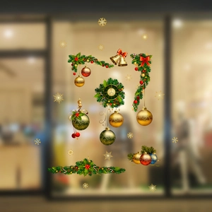 Detail of Christmas window stickers featuring golden bells and festive wreaths on glass