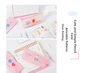 Detail of pink mesh and floral pencil cases with cute strawberry patterns on a desk