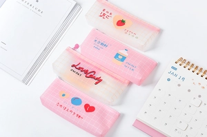 Detail of pink and white grid pencil case with zipper and Japanese lettering