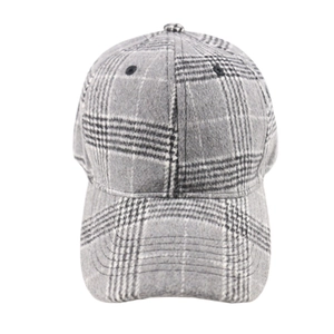 Macro detail of grey plaid baseball cap showing premium wool-like textured fabric and pattern