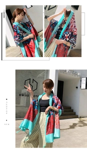 Detailed view of lightweight ethnic print shawl with fringe and geometric flower patterns