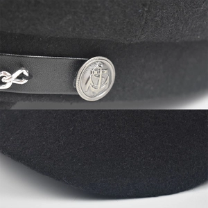 Black wool newsboy cap with PU leather strap and silver metal chain detail on white background