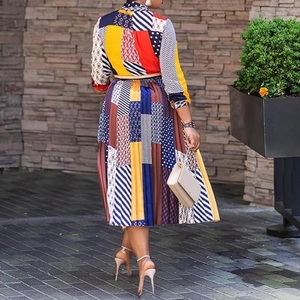 African print pleated midi dress with butterfly collar and colorful geometric patterns