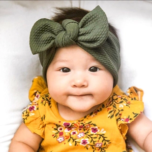 Detailed close-up of army green waffle knit baby headband with 3D bunny ears bow style