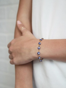 Close-up of Turkish evil eye bracelet in gold finish worn on a woman's wrist