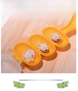Close-up of three-hole DIY rice ball mold in yellow plastic for kids' kitchen meals