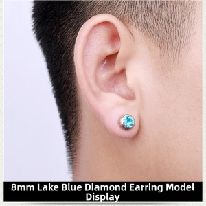 Close-up of 8mm blue zircon magnetic earring on male ear in polished stainless steel