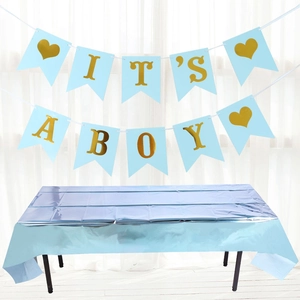 Detail of light blue party tablecloth and golden IT'S A BOY banner decoration