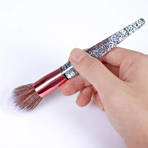 Detail showing soft pink synthetic bristles and rose gold ferrule of the makeup brush