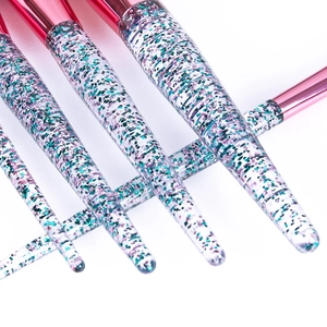 Close-up of clear acrylic brush handles filled with colorful glitter and sequins