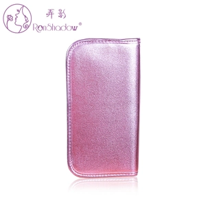 Close-up of pink glittery makeup brush bag with metallic texture and zipper closure