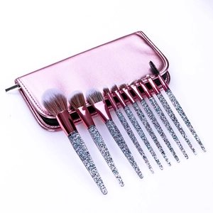 Macro shot of 12-piece pink glitter makeup brushes with glossy metallic zipper pouch