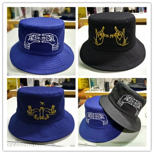 Detailed view of custom embroidery on cotton bucket hats in dark blue and black colors