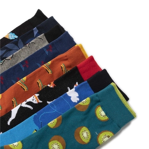 Detailed view of colorful mid-calf socks with kiwi and animal prints in soft cotton knit