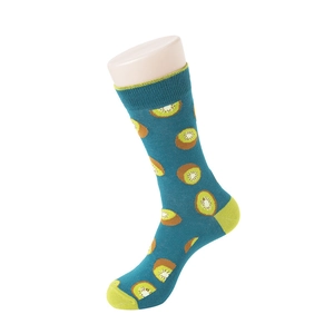 Detail of teal crew socks with kiwi fruit pattern and neon green heel and toe accents