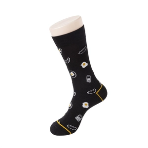 Detail of black crew socks featuring fun breakfast patterns like fried eggs and sausages