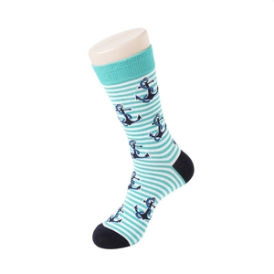 Detail of mint green striped socks with navy anchor pattern on a foot model