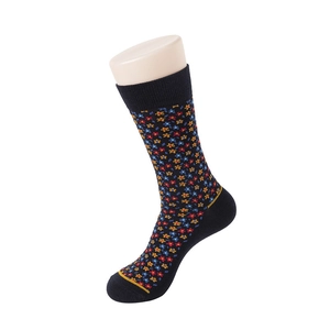 Detail of navy blue cotton socks with colorful floral patterns on mannequin model