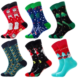 Detail view of six pairs of men's cotton crew socks with festive Christmas themed patterns