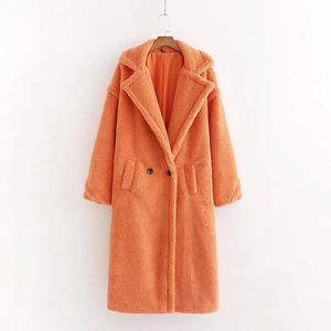 Detail of long orange teddy fleece coat featuring lapel collar, buttons and pockets