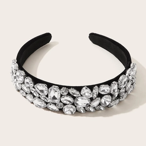 Detail of wide black fabric headband densely embellished with clear geometric rhinestones