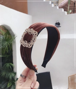 Detail of brown velvet headband with sparkling rhinestone square buckle decoration