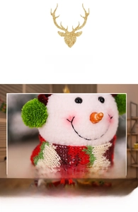 Close-up of plush snowman doll with green earmuffs and red striped scarf for Christmas