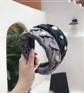 Detail of wide woven headbands in grey and black satin fabric with clear crystal rhinestones