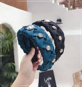 Detail of woven velvet headband set with sparkling rhinestones in black and peacock blue