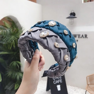 Elegant woven headband with rhinestones in peacock blue and grey colors on silk satin fabric