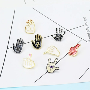 Cartoon rock gesture enamel pins set with creative metal drip oil designs for clothing