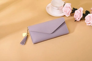 Light purple long wallet with lychee texture featuring tassel and gold heart pendant