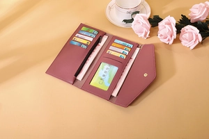 Detail view of pink long wallet interior with multi-card slots and clear ID window