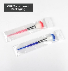 Detail showing pink and blue makeup brushes with crystal diamond filled handles in OPP bags